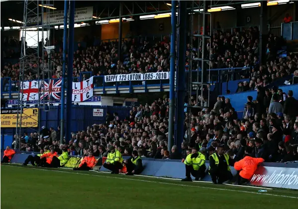  ?? ?? The large crowd behind a row of stewards