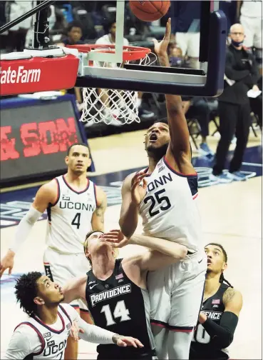  ?? David Butler II / USA Today ?? UConn forward Josh Carlton (25) works for a rebound against Providence forward Noah Horchler (14) on Feb. 16 in Storrs.