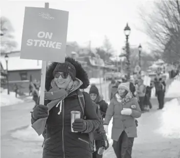  ?? [VERONICA REINER] ?? Catholic school teachers in the region were off the job Tuesday, with some marching through downtown Elmira, home to Conservati­ve MPP Mike Harris' office.