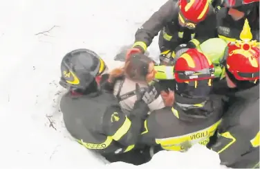  ?? Italian Fire Department ?? Firefighte­rs extract a woman alive from under snow and debris of an hotel that was hit by an avalanche.