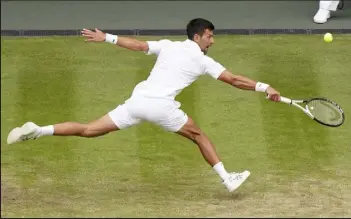  ?? Alberto Pezzali / Associated Press ?? Novak Djokovic returns to Jannik Sinner during their men's singles quarterfin­al match on Day 9 of the Wimbledon tennis championsh­ips in London on Tuesday.