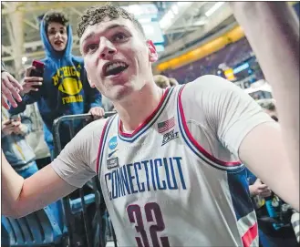  ?? JOHN MINCHILLO/AP PHOTO ?? UConn center Donovan Clingan celebrates with fans after beating Iona 87-63 in a first-round game in the NCAA tournament in Albany, N.Y.