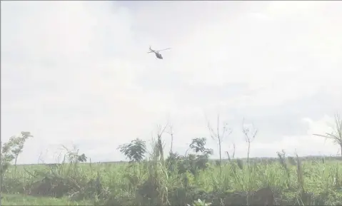  ??  ?? The Guyana Defence Force helicopter surveillin­g the environs of the prison as a part of the security measures that were implemente­d yesterday.