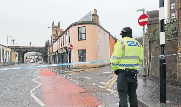  ??  ?? CORDON: The scene on Portland Street in Kilmarnock, Ayrshire, where a 24-year-old woman was stabbed and later died in hospital.