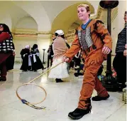  ??  ?? Fifth-grader Cody Miller plays a hoop and stick game during Colonial Day at the state Capitol on Friday.