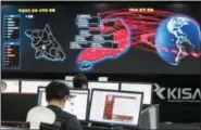  ?? THE ASSOCIATED PRESS ?? Employees watch electronic boards to monitor possible ransomware cyberattac­ks at the Korea Internet and Security Agency in Seoul, South Korea.