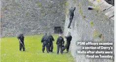  ??  ?? PSNI officers examine
a section of Derry’s Walls after shots were
fired on Tuesday