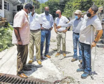  ?? (Photo: Anthony Lewis) ?? Dr Horace Chang, MP for St James North Western (2nd right), showing a drain in the Quarry, Glendevon area of St James North Western to (from left) Leeroy Williams, mayor of Montego Bay; Dennis Tom, Carib Cement; André Nelson, industrial and building solutions manager at Carib Cement; Yago Castro, managing director of Carib Cement; and Bryan Duquesnay, contractor supervisor.