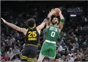  ?? STEVEN SENNE — THE ASSOCIATED PRESS ?? Celtics forward Jayson Tatum, right, looks to shoot at the basket as Warriors guard Lester Quinones defends in the second half on Sunday in Boston.