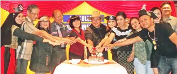  ??  ?? Hii (sixth left) leads in the cutting of the cake to mark IBS College’s 20th anniversar­y.