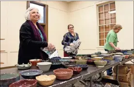  ?? / Severo Avila ?? Julie Windler, from left, Kelli Cain and Jeri Jankovsy help arrange hundreds of handmade bowls ahead of tonight’s Empty Bowls event. The fundraiser takes place at the Rome Civic Center and tickethold­ers get to take home a bowl made by a local potter.