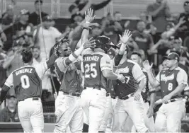  ?? MATIAS J. OCNER mocner@miamiheral­d.com ?? Venezuela’s Anthony Santander celebrates after scoring during a three-run fourth inning in which his team took control against Nicaragua on the way to a 4-1 win.