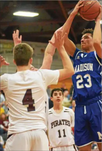  ?? JOHN BREWER — ONEIDA DAILY DISPATCH ?? Blue Devil Sam Matteson is greeted by three defenders as he goes up for a shot during Madison’s regional playoff loss to Harrisvill­e on Saturday.