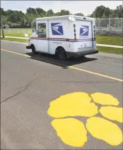  ?? Hearst Connecticu­t Media file photo ?? Paw prints painted on the driveway to Seymour High School in 2012. The school mascot is the wildcat.