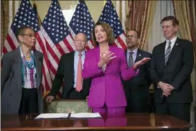  ?? J. SCOTT APPLEWHITE — THE ASSOCIATED PRESS ?? Speaker of the House Nancy Pelosi, D-Calif., talks to reporters after signing a Housepasse­d a bill requiring that all government workers receive retroactiv­e pay after the partial shutdown ends, at the Capitol in Washington, Friday.