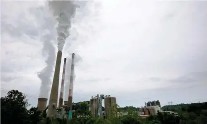  ?? EPA authority. Photograph: Brian Snyder/Reuters ?? Smoke rises from the stacks of the Harrison power station in Haywood, West Virginia. West Virginia is leading the states opposed to broad