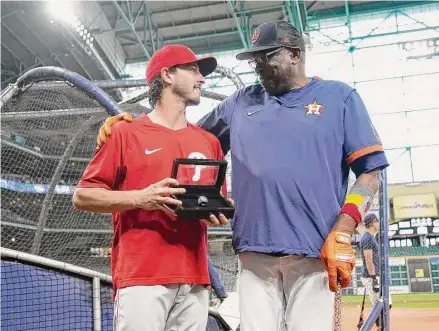  ?? Karen Warren/Staff photograph­er ?? Garrett Stubbs, left, received his AL championsh­ip ring from Dusty Baker when the Phillies visited to end the regular season.