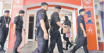  ??  ?? Police personnel patrolling the Putra World Trade Centre (PWTC) in Kuala Lumpur. — Bernama photo