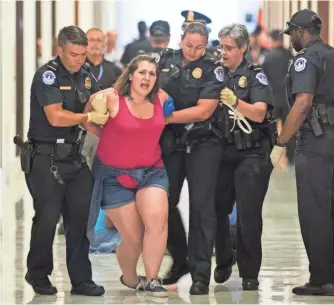 ?? JIM LO SCALZO, EUROPEAN PRESSPHOTO AGENCY ?? U.S. Capitol police arrest a woman protesting Senate Republican­s’ health care bill Wednesday.