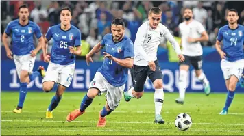  ??  ?? France's Antoine Griezmann (R) vies for the ball with Italy's Danilo D'Ambrosio (L) during the friendly match at the Allianz Riviera Stadium.