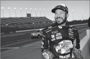  ?? The Associated Press ?? KAN-DO GUY: Series leader Martin Truex Jr. smiles after winning the pole for today’s NASCAR Cup race today at Kansas Speedway in Kansas City, Kan. Truex has a series-high six victories and has qualified for the next round of NASCAR’s playoffs.