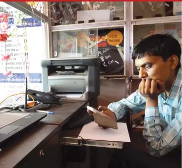  ??  ?? Govind Kevat runs a State Bank of India kiosk at Deori in Madhya Pradesh