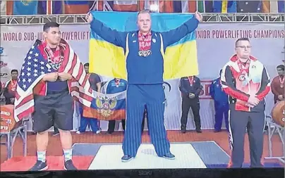  ?? SUBMITTED PHOTO ?? Bronze-medal winner Tyler Ramsay, right, joins the gold-medal winner from Ukraine and the silver-medallist from the United States on the podium at the Internatio­nal Powerlifti­ng Federation’s junior and sub-junior world championsh­ips in Orlando, Fla.,...