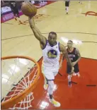  ?? The Associated Press ?? Golden State Warriors’ Andre Iguodala scores past Houston Rockets Gerald Green during Game 1 of the NBA Western Conference final on Monday in Houston.