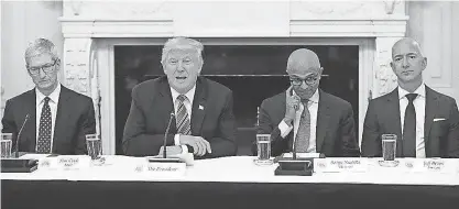  ?? CHIP SOMODEVILL­A, GETTY IMAGES ?? President Trump with members of his American Technology Council, including, left to right, Apple CEO Tim Cook, Microsoft CEO Satya Nadella and Amazon CEO Jeff Bezos at the White House on Monday.