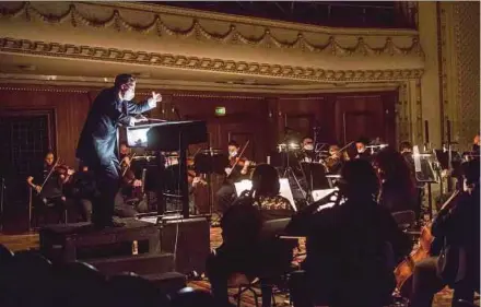  ?? AFP PIC ?? A conductor wearing a face mask conducting the Sofia Opera orchestra during the opera ‘La Traviata’ at the Sofia Opera recently.