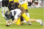  ?? MATT YORK/ASSOCIATED PRESS ?? Cal’s Davis Webb, who was intercepte­d twice in the fourth quarter, is sacked by Arizona State’s Koron Crump.