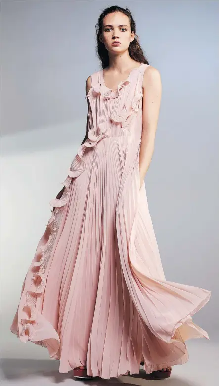  ??  ?? A model wears a pink gown from the H&M Conscious Exclusive collection.