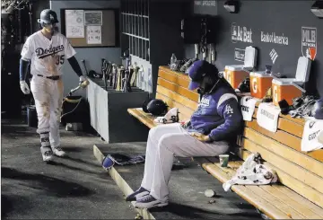  ?? Matt Slocum ?? The Associated Press Dodgers closer Kenley Jansen sits in the dugout during the ninth inning of Game 2, an 11-inning loss for Los Angeles.