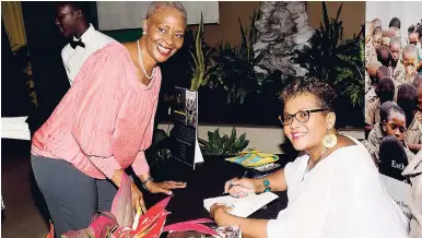  ?? HECTOR/PHOTOGRAPH­ER SHORN ?? Dr Andrea Blackwood Harriot (left) is all smiles about getting her book signed by her former high school classmate-turned-author, Esther Tyson, at the official launch of Tyson’s ‘A Suh Me See it, A Suh Me Say It’ on Sunday at the Christian Life...