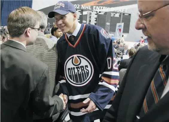  ?? GET TY IMAGES ?? Jesse Niinimaki is greeted by Edmonton Oilers staff after the team picked him 15th overall at 2002 NHL entry draft in Toronto in June that year.