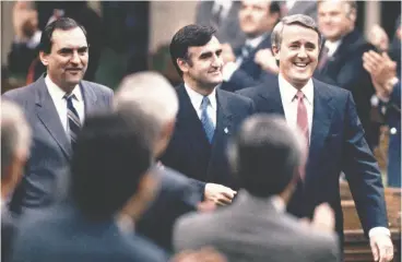  ?? RON POLING / CP FILES ?? Mulroney and Tory House Leader Don Mazankowsk­i march secretary of state Lucien Bouchard into the House to take his seat after he was sworn in on June 28, 1988.