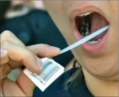  ?? Dan Watson/The Signal ?? Claudia Chavelas uses a bar-coded swab to collect DNA during a recent Be The Match drive-in event in Valencia to find potential bone marrow donors.