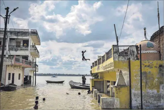  ?? Photo: Sanjay Kanojia/afp ?? Liquid playground: A child jumps into floodwater­s after heavy monsoon rains swelled the Ganges and Yamuna rivers and caused flooding in the Jhusi area of Allahabad, India, earlier this month.