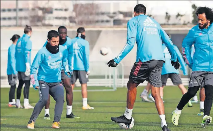  ??  ?? Hazard, Varane, Marcelo y Casemiro, de izquierda a derecha en primer término, en un rondo en el inicio del entrenamie­nto de ayer.