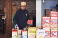  ?? Tyler Sizemore / Hearst Connecticu­t Media file photo ?? Volunteers stack food donations for Neighbor to Neighbor in Greenwich on March 31, 2020. The Parish of St. Catherine of Siena and St. Agnes accepts food donations to benefit Neighbor to Neighbor from 9 to 11 a.m. Tuesdays in its parking area across from the rectory at 4 Riverside Ave. Items needed include peanut butter and jelly, oatmeal, canned meat, tuna, canned fruit, dried or canned beans, cereal, rice and soup as well as as household cleansers and toiletries.