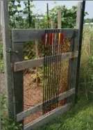  ??  ?? An archer decorates his garden gate with arrows.