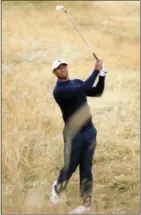  ?? PETER MORRISON — THE ASSOCIATED PRESS ?? Tiger Woods plays out of the rough on the second hole during practice for the British Open in Carnoustie, Scotland on Tuesday.