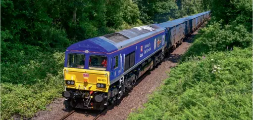  ?? Kevin Delaney ?? The top prize on offer for the Rcts/mortons Photograph­ic Competitio­n is a money-cannot-buy carbide in a Class 66 courtesy of DB Cargo. On June 22, 2023, DB Cargo’s King’s Coronation blue 66023 heads away from Rainford.