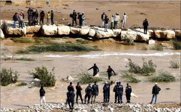  ??  ?? Civil defence members look for missing persons after rain storms unleashed flash floods, in Madaba city, near Amman, Jordan. — Reuters photos