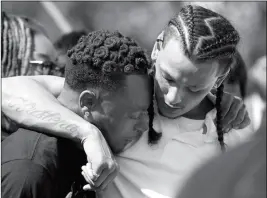  ?? ASSOCIATED PRESS ?? MOURNERS COMFORT EACH OTHER AT THE GRAVESITE of police shooting victim Stephon Clark after his funeral Thursday in Sacramento, Calif. Clark who was unarmed, was shot and killed by Sacramento Police officers Sunday.