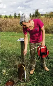  ?? CONTRIBUTE­D ?? Elli Sigmond, a hydro technician at the Miami Conservanc­y District, takes a groundwate­r measuremen­t at an observatio­n well in Hamilton County to track changes to water levels in the Buried Valley Aquifer