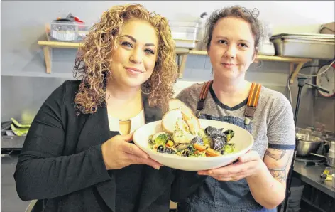  ?? COLIN MACLEAN/JOURNAL PIONEER ?? Open Eats executive chef Megan Beairsto, right, and Guardian food columnist chef Ilona Daniel present Beairsto’s dish of Seafood Hodgepodge.