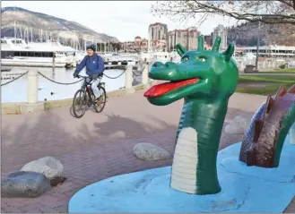  ?? STEVE MacNAULL/The Okanagan Weekend ?? When the grass is green and people are still riding their bikes along Kelowna’s waterfront, it doesn’t begin to look much like Christmas in the Okanagan. There may be a dusting of snow this weekend, but it likely will be gone by the time Christmas Day rolls around.