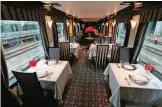  ??  ?? A dining car of Japan's latest super-deluxe cruise train "Twilight Express Mizukaze" during its press preview in Osaka. — AFP photosGour­met grub, cypress tubs