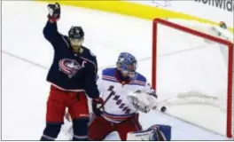  ?? PAUL VERNON — THE ASSOCIATED PRESS ?? Columbus’ Nick Foligno, left, reacts in front of Rangers goalie Henrik Lundqvist after a goal by the Blue Jackets’ Artemi Panarin during the third period in Columbus, Ohio on Friday.